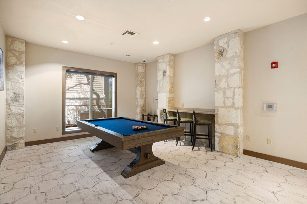 a game room with a pool table and a bar at Lakeline East Apartments, Texas