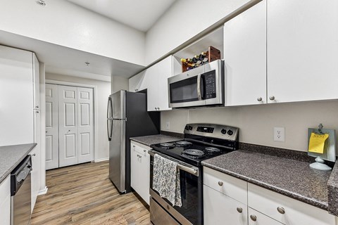 A kitchen with a stove top oven and a microwave above it.