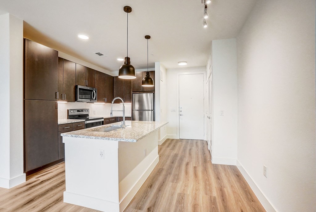 a kitchen with a large island and a stainless steel refrigerator at Aurora Watson Branch, Texas, 76063