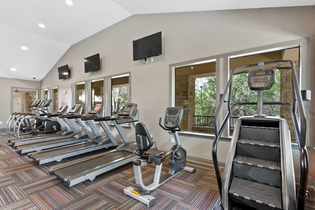 a row of cardio machines in a gym at The Verandah, Austin, 78726