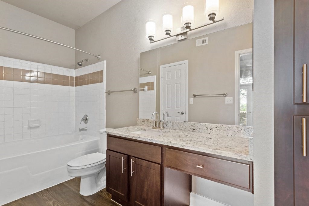 a bathroom with a toilet sink and bathtub at The Verandah, Texas, 78726
