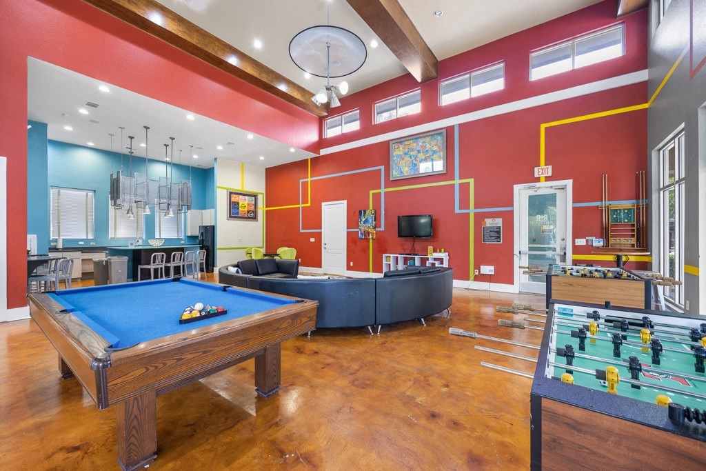 a game room with a pool table and foosball at Artisan Apartments & Shops, Austin, TX
