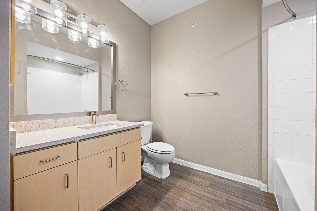 a bathroom with a toilet sink and shower at Artisan Apartments & Shops, Austin, TX