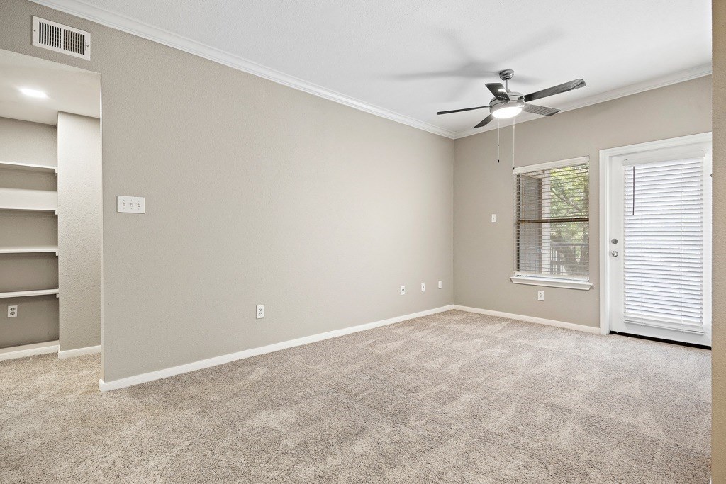Living rooms with natural light and built in shelving at Artisan Apartments & Shops, Texas