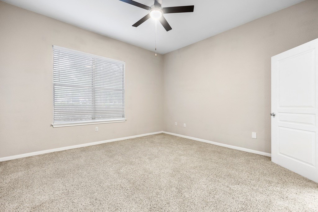 a bedroom with a ceiling fan at Artisan Apartments & Shops, Austin