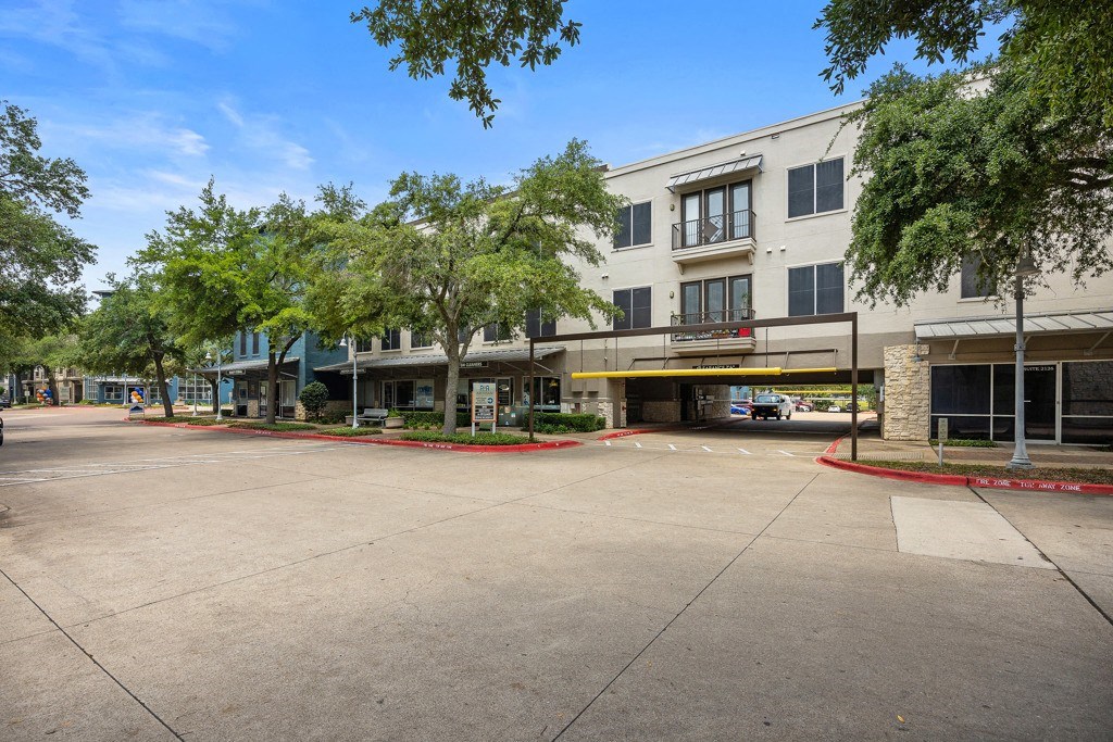 a building with a parking lot in front of it at Artisan Apartments & Shops, Austin, TX