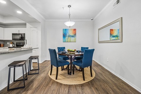 A dining room with a table set for four.