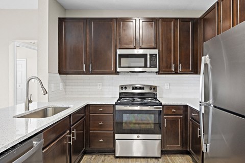 a kitchen with stainless steel appliances and wooden cabinets