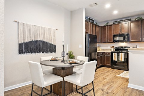 a kitchen and dining room with a table and chairs