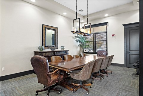Conference room with wooden table and leather chairs at Las Brisas Apartments, Texas, 78665