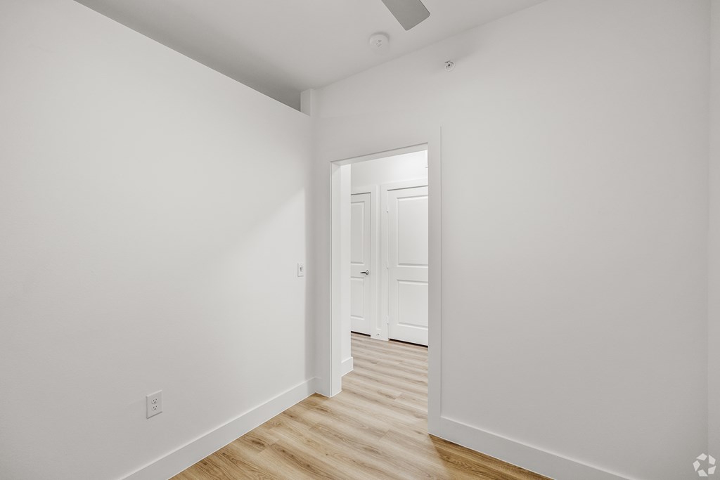 A white hallway with a door at the end. at Aurora Watson Branch, Texas, 76063