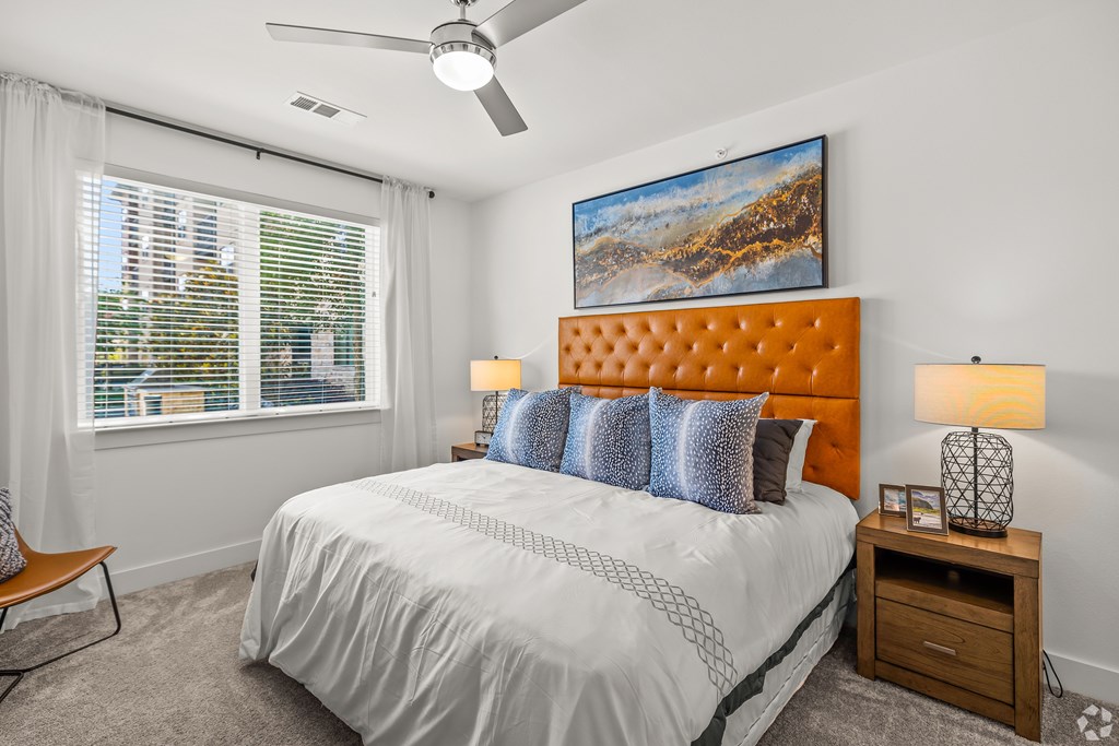 A bedroom with a large bed, a ceiling fan, and a painting on the wall. at Aurora Watson Branch, Texas, 76063
