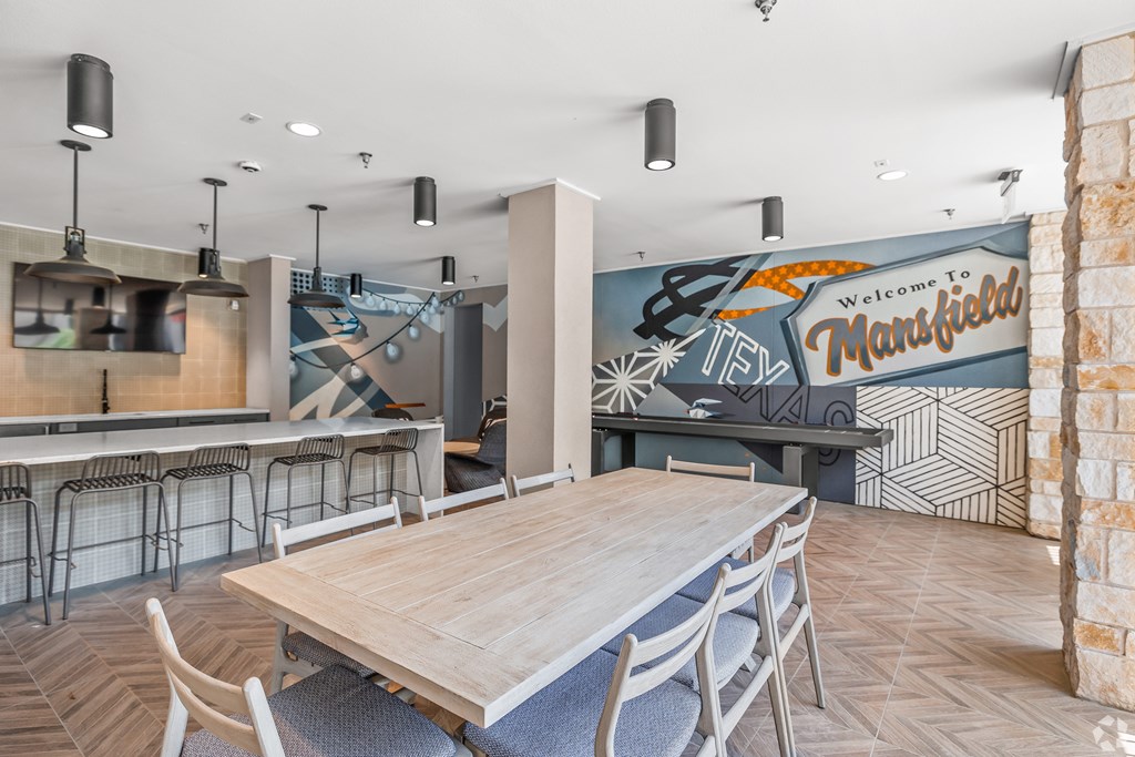 A room with a wooden table and chairs and a mural on the wall. at Aurora Watson Branch, Texas, 76063