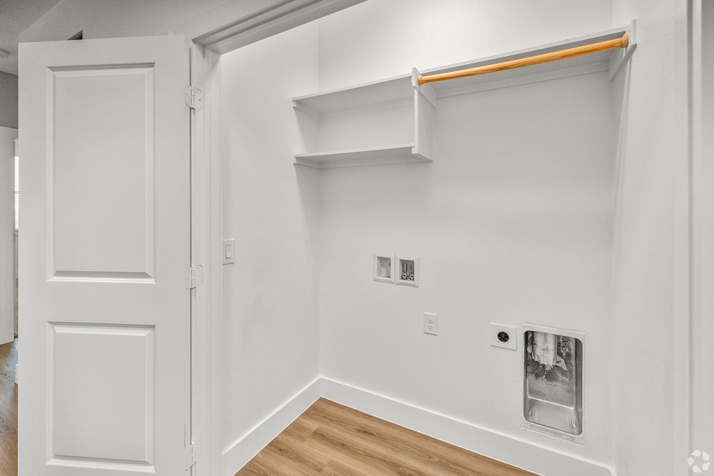 A white room with a door and a shelf. at Aurora Watson Branch, Mansfield, 76063
