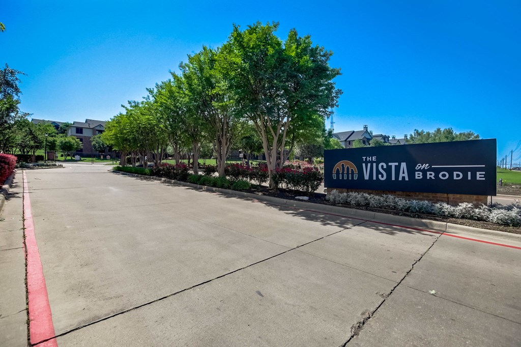 the sign for the westboro at the entrance to a street with trees and buildings