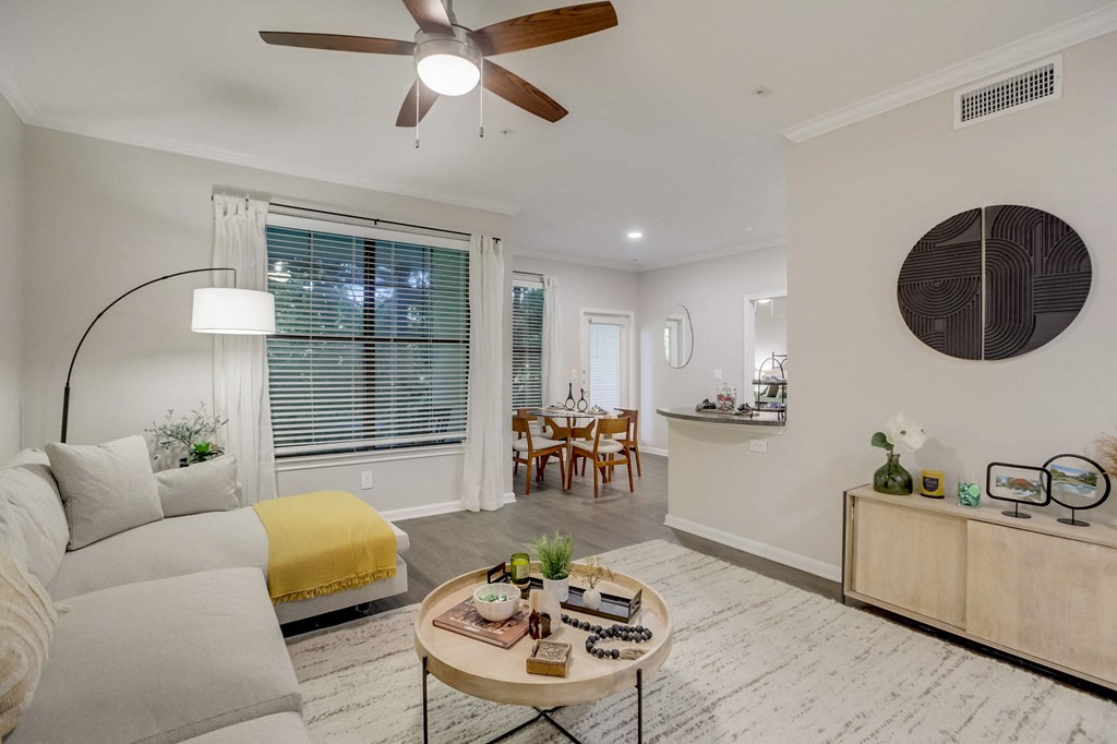 a living room with a couch and a ceiling fan