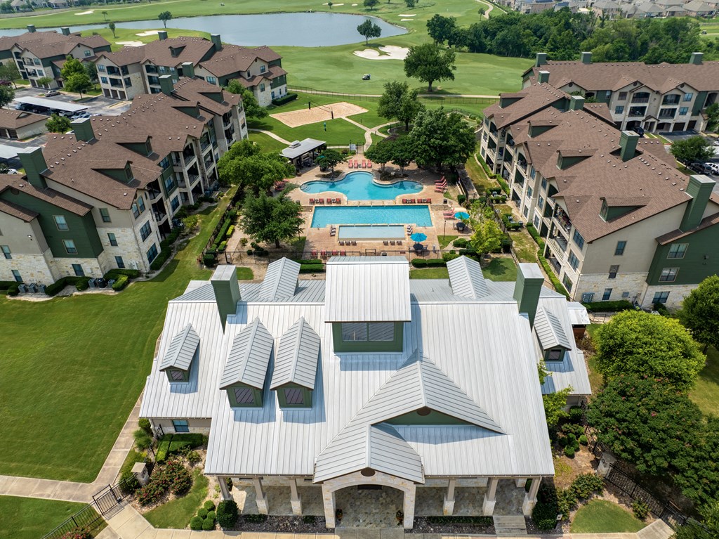 an aerial view of an apartment complex with a swimming pool