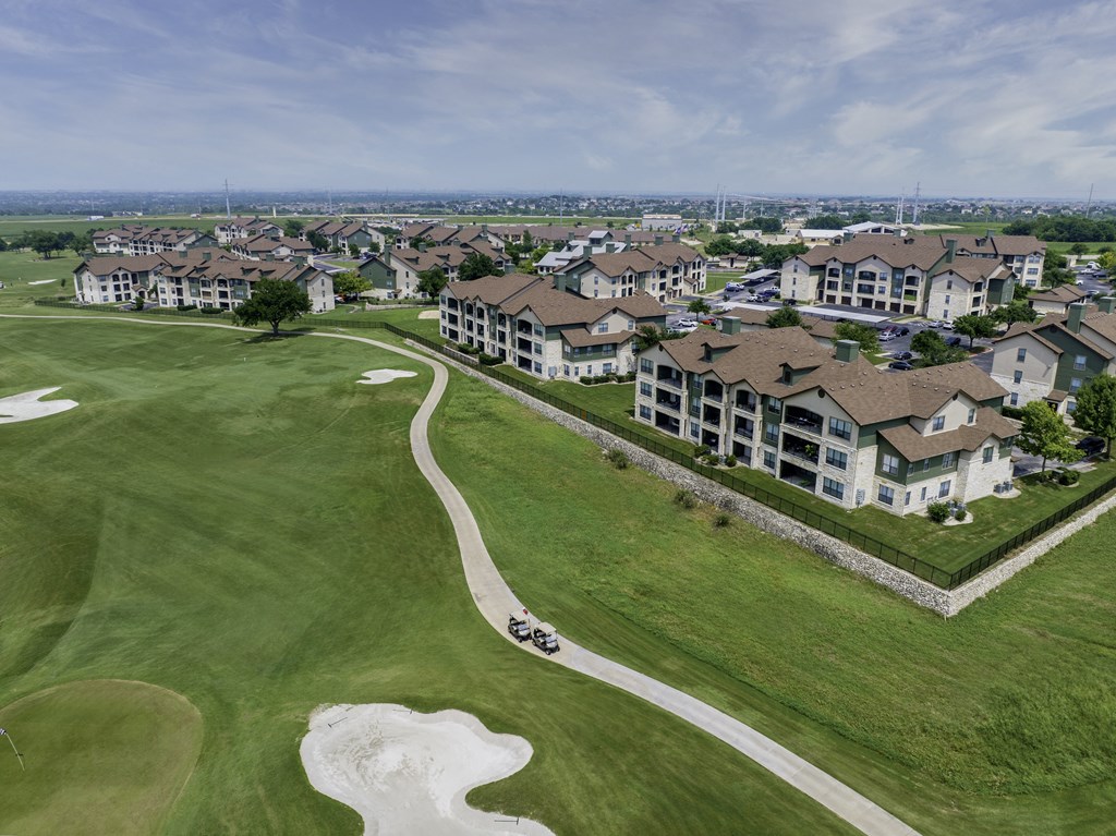 an aerial view of a neighborhood with houses and a golf course
