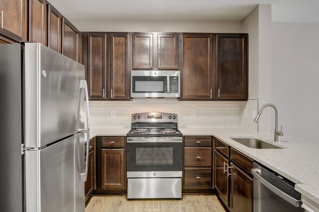 a kitchen with stainless steel appliances and wooden cabinets
