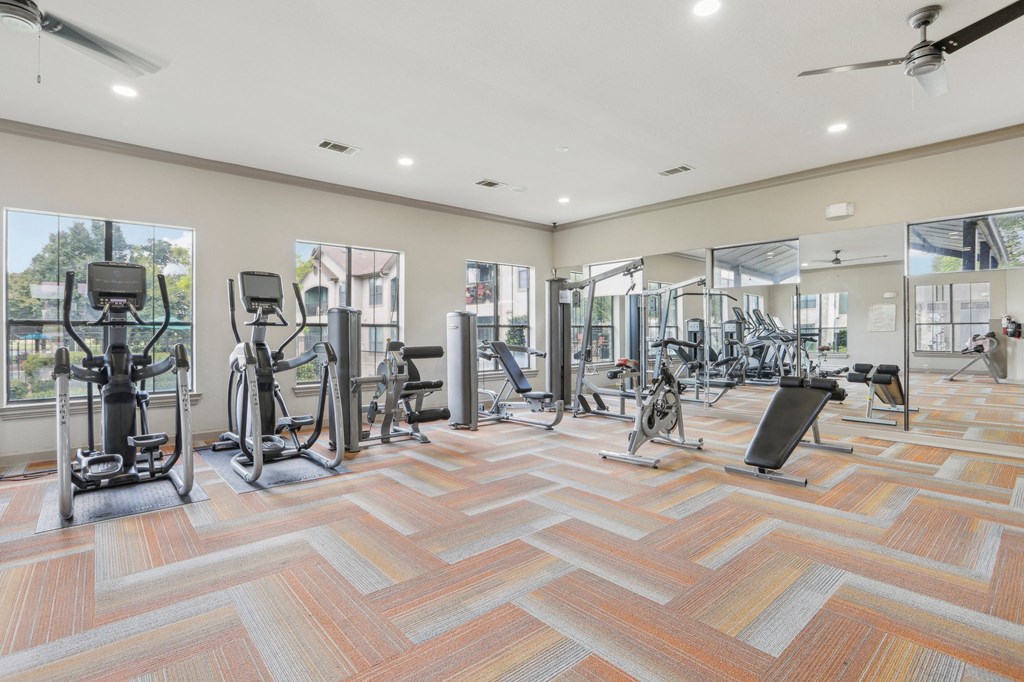 fitness center with weights and cardio equipment