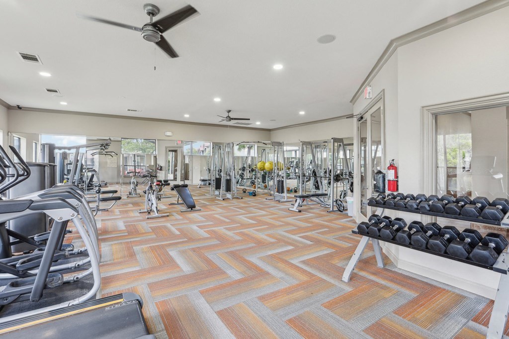 the generously sized gym is equipped with cardio machines and weights