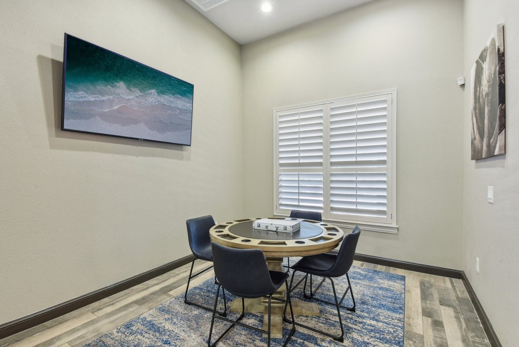 a dining room with a table and chairs and a painting on the wall at Sonterra Apartment Homes, Austin