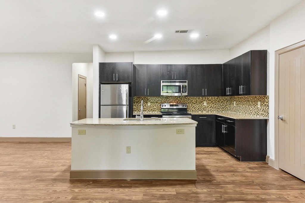 a large kitchen with a large island in the middle of it at Lakeline East Apartments, Cedar Park, 78613