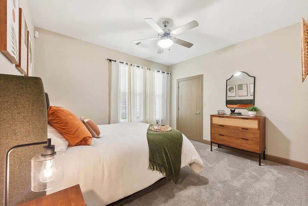 a bedroom with a bed and a ceiling fan at Lakeline East Apartments, Texas, 78613