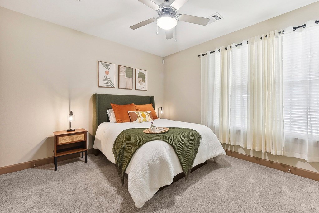 a bedroom with a bed and a ceiling fan at Lakeline East Apartments, Cedar Park
