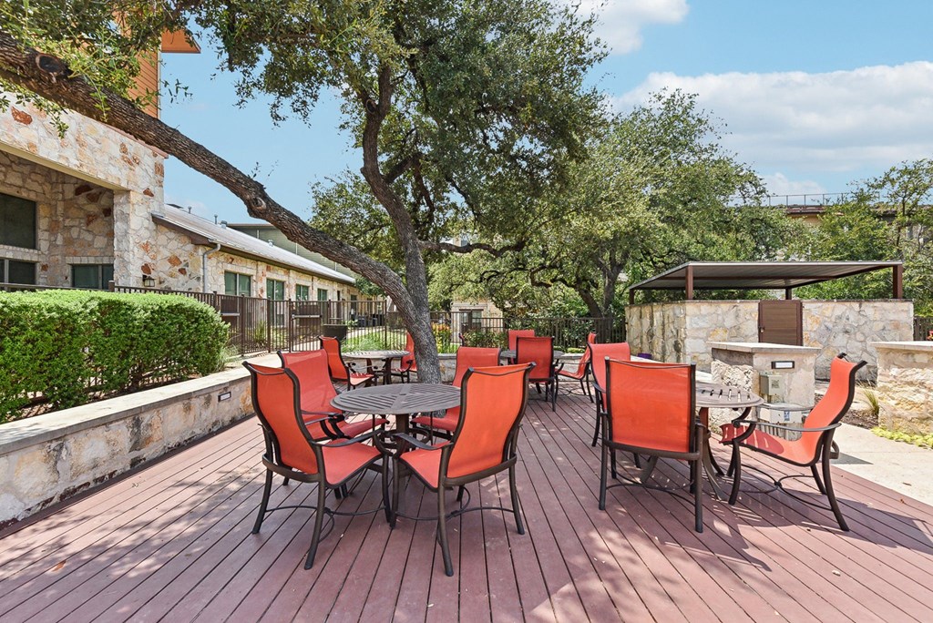 a patio with a table and chairs and a fire pit at Lakeline East Apartments, Cedar Park, TX