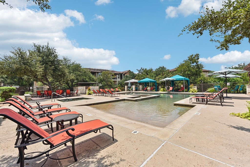 the preserve at ballantyne commons community swimming pool with red benches at Lakeline East Apartments, Texas, 78613