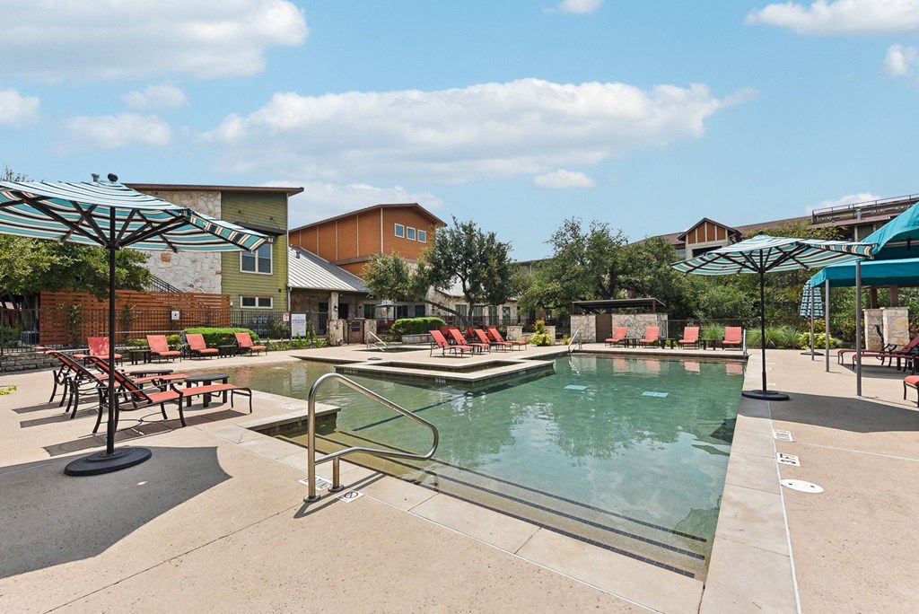 a view of a water park with a pool and buildings at Lakeline East Apartments, Cedar Park