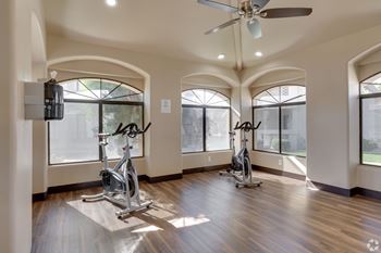 A room with a wooden floor and a ceiling fan. at San Montego Apartments, Mesa, 85206