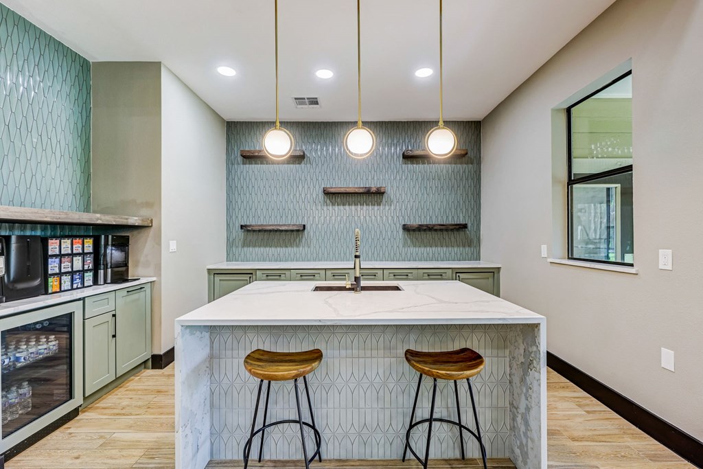 a kitchen with two stools in front of a counter top at Ventana Oaks Apartments, Austin, 78717