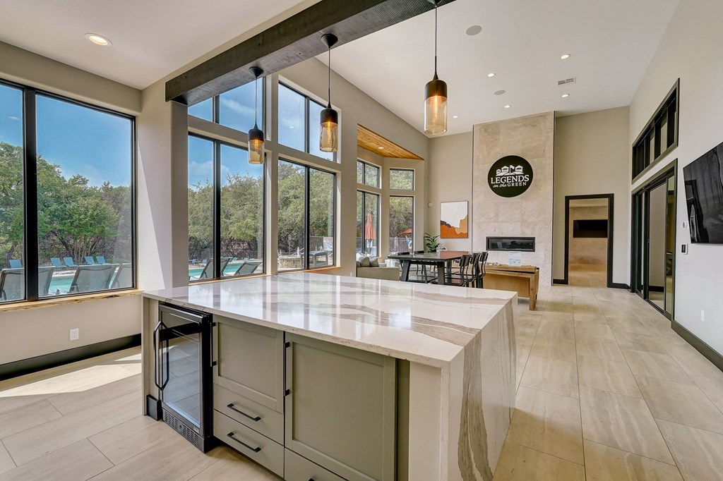 a large kitchen with a large island and large windows at Legends on the Green Apartments, Texas