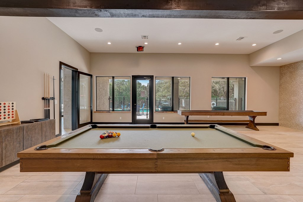 pool table in the clubhouse of a house with two pool tables at Legends on the Green Apartments, San Antonio 78232