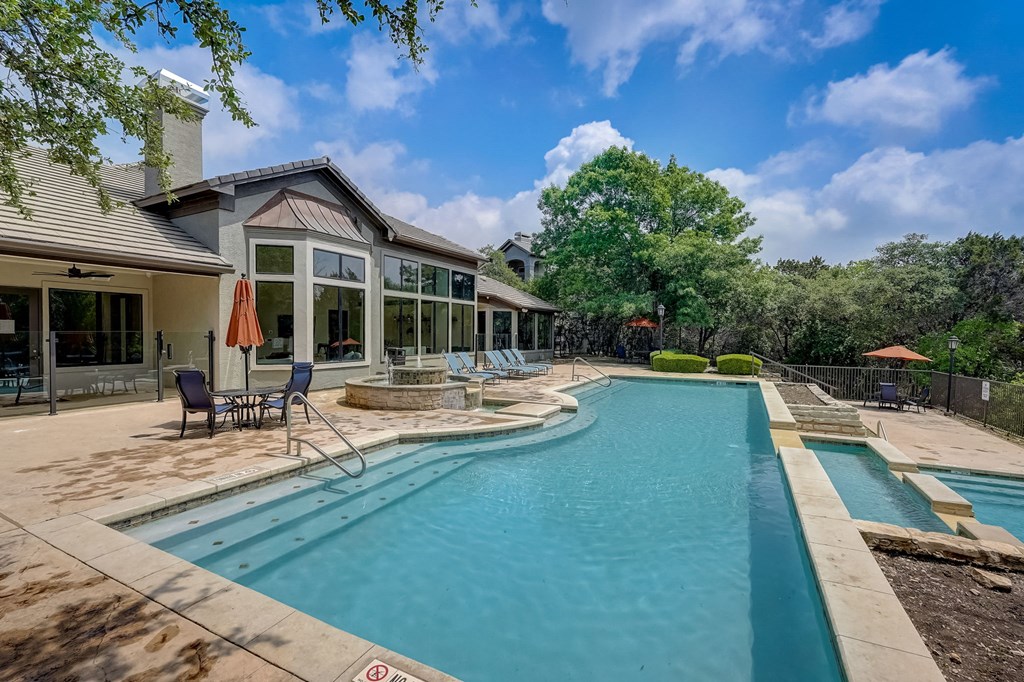 a swimming pool with a house in the background