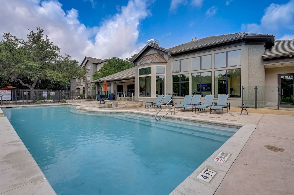 a building with a pool at Legends on the Green Apartments, Texas, 78232