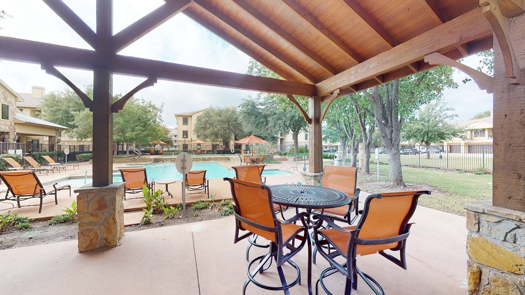 Outdoor lounge and poolside seating at The Canyons Apartments, Fort Worth, 76116