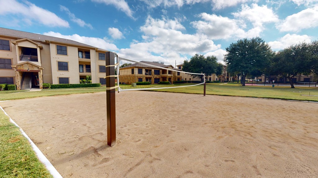 outdoor sand volleyball court at The Canyons Apartments, Fort Worth, 76116