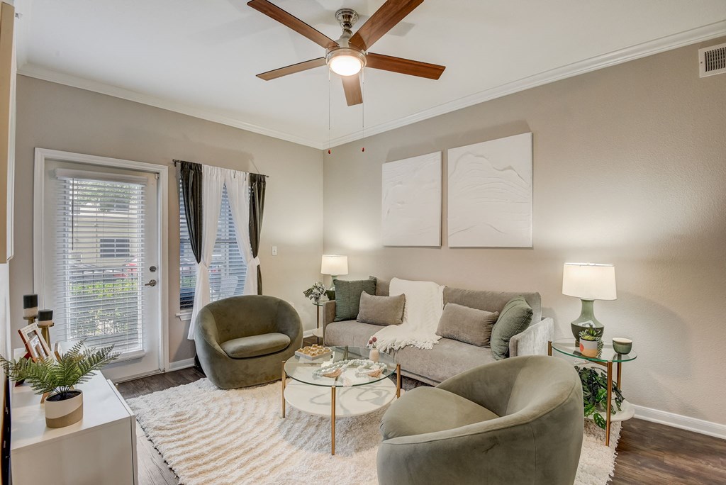a living room with a ceiling fan and a couch