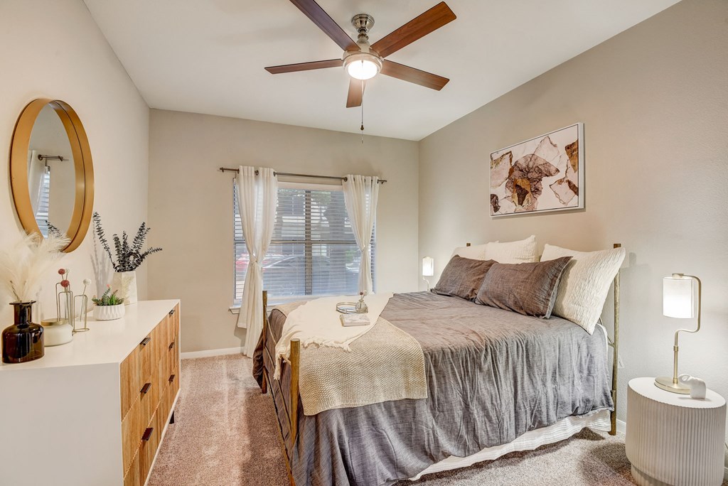 Primary bedroom with dresser at Artisan Apartments & Shops, Austin, TX