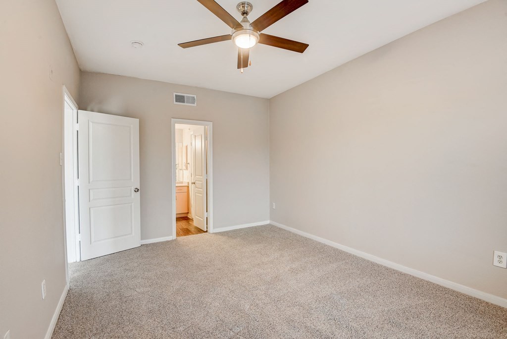 an empty living room with a ceiling fan at Artisan Apartments & Shops, Austin, TX, 78729