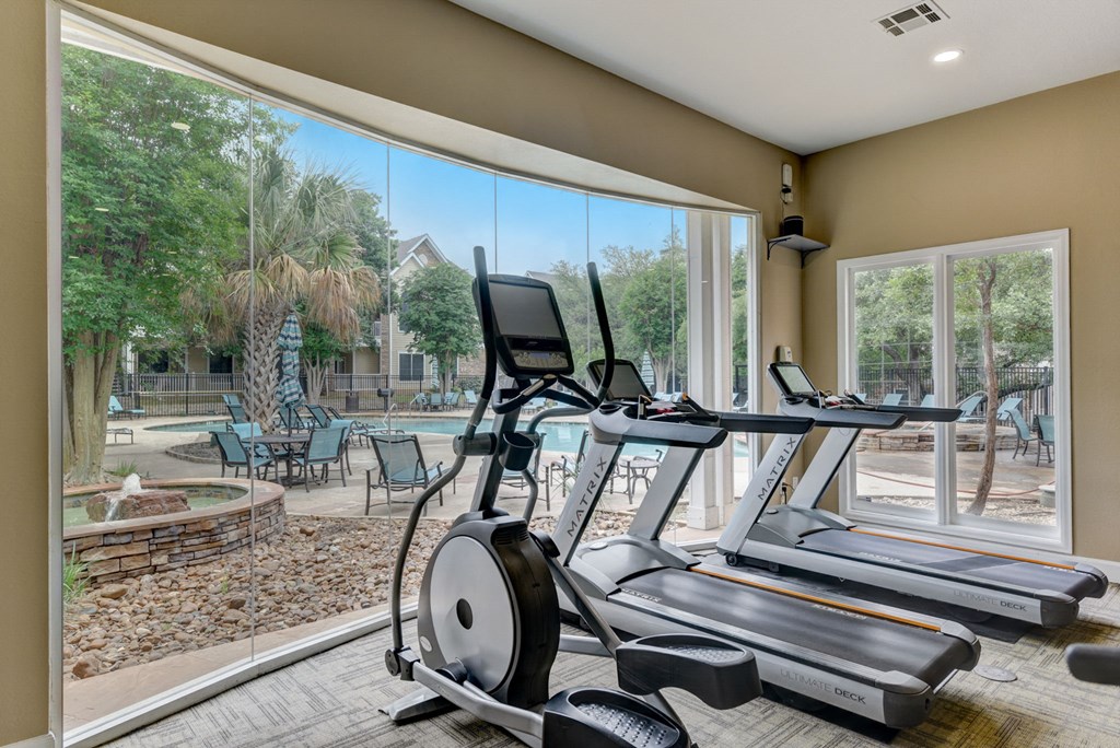the residence on lamar apartment homes fitness center with gym equipment and large windows