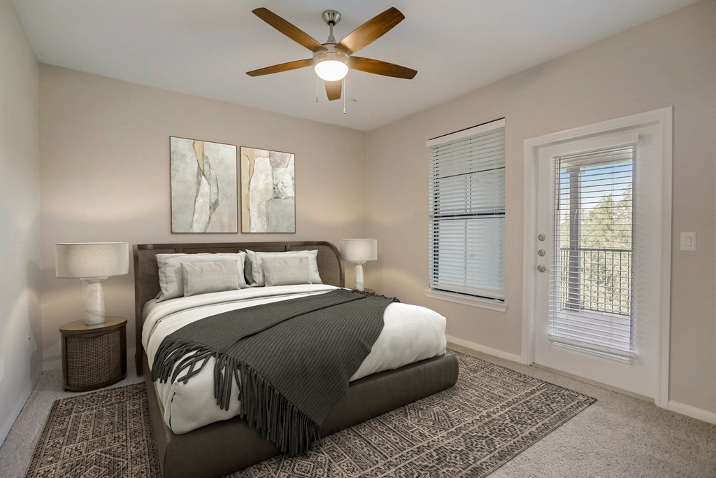 a bedroom with a bed and a ceiling fan