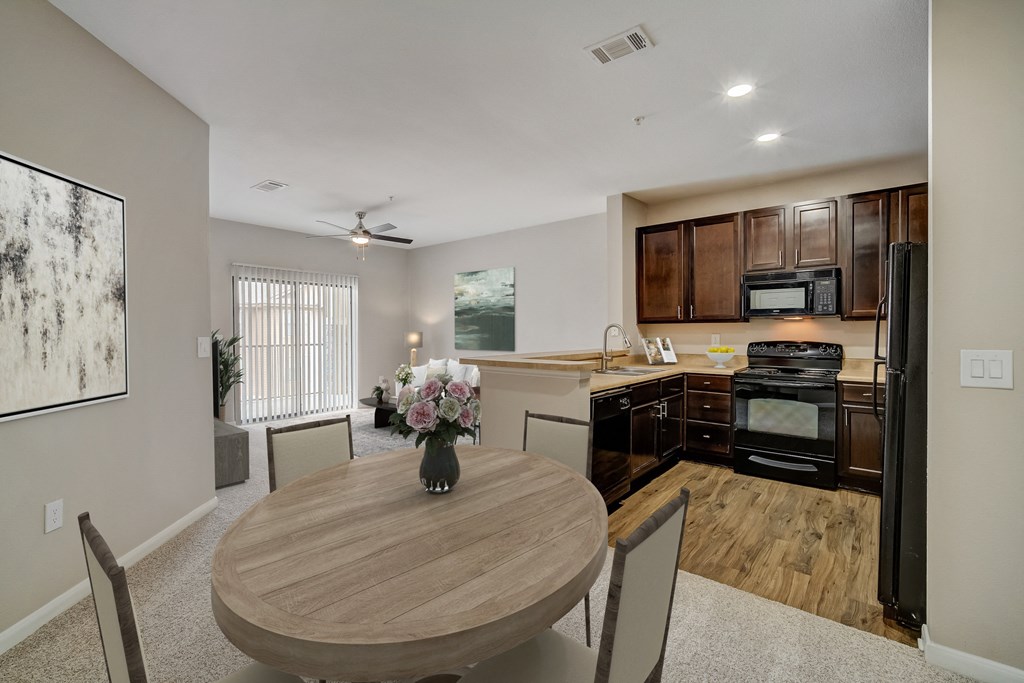 an open kitchen and dining room with a table and chairs
