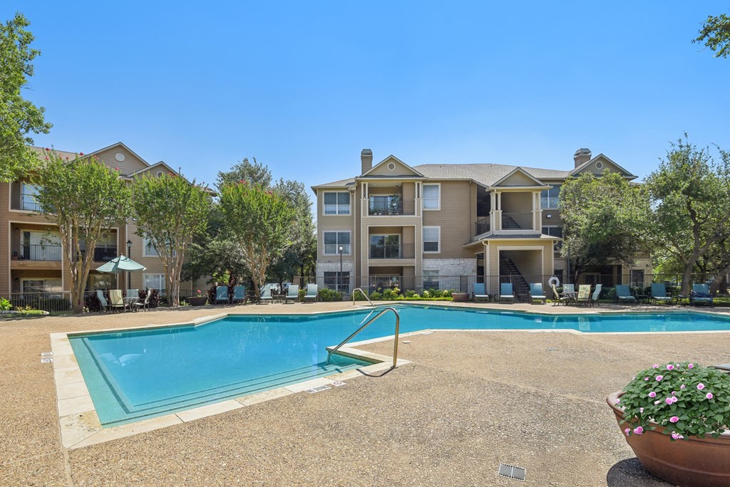 a swimming pool with an apartment building in the background at Sonterra Apartment Homes, Austin, 78726
