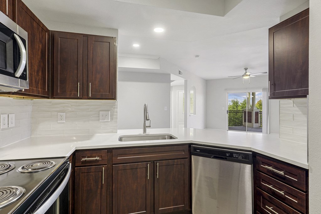 a kitchen with white countertops and wooden cabinets at The Legends at Eagle Mountain Lake, Fort Worth, TX, 76179
