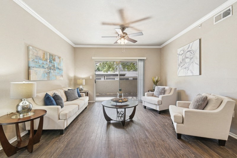 a living room with furniture and a ceiling fan at Legends on the Green Apartments, San Antonio, TX