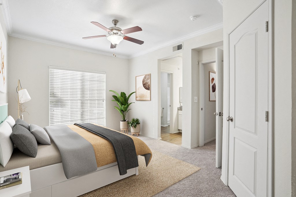 a bedroom with a bed and a ceiling fan at La Ventura Apartments, Texas, 75093